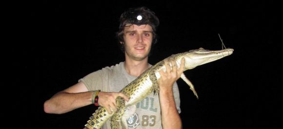 Luke Evans holding a small crocodile