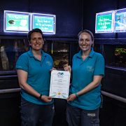 Hannah Thomas and Gabby Drake pictured in the Aquarium at Chester Zoo with their BIAZA award