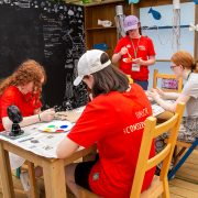 A group of young people pictured at Chester Zoo creating arts and crafts activity