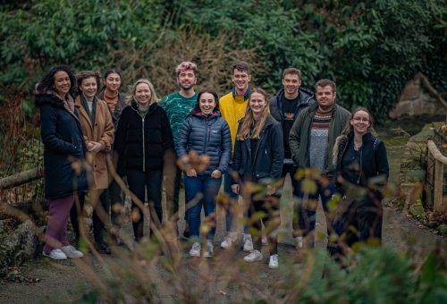 An image of 13 young people (male and female aged 18-26) who make up Chester Zoo's Youth Board