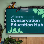 A digital sign reading "Welcome to the Conservation Education Hub"