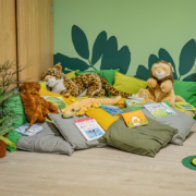 A book corner with cuddly toys and books