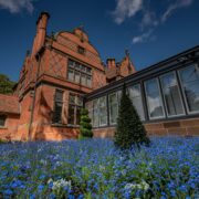 Exterior of The Oakfield at Chester Zoo, there's blue flowers in the forefront