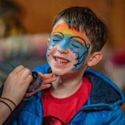 child getting face painted at children's birthday party - mobile banner
