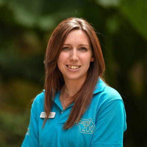 Photo of Cat Barton in Chester Zoo uniform, smiling at the camera