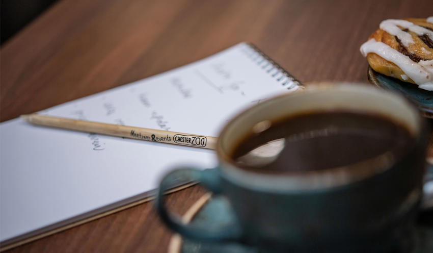 Close Up Of A Notebook And Coffee In A Meeting Room