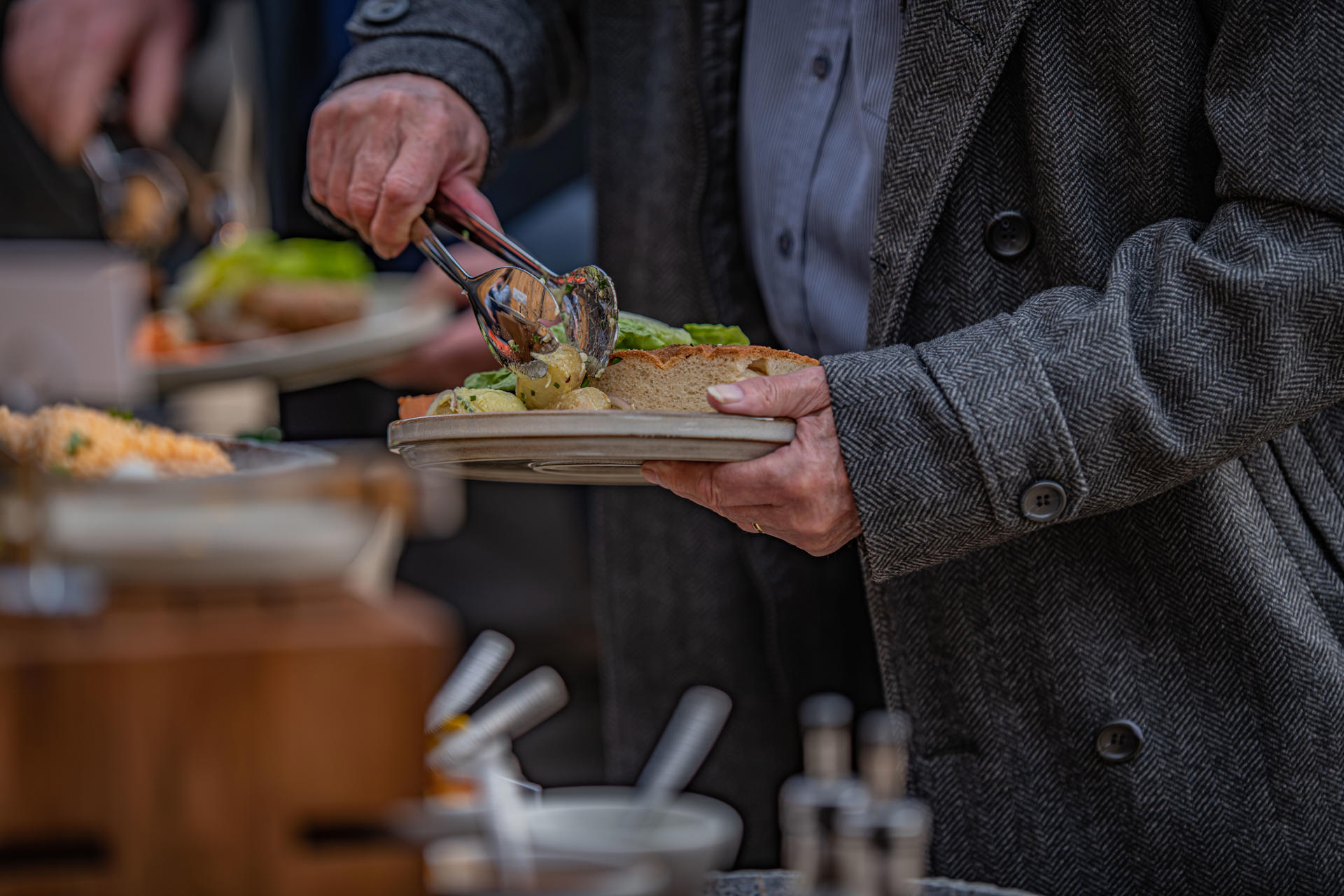 Man Loading A Plate Of Food At The Square