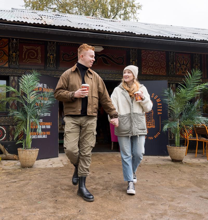 Couple Walking With Coffee