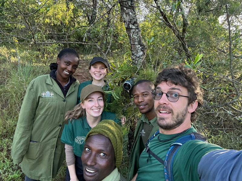 The field teams members pose in front of a hidden camera in Semuliki.