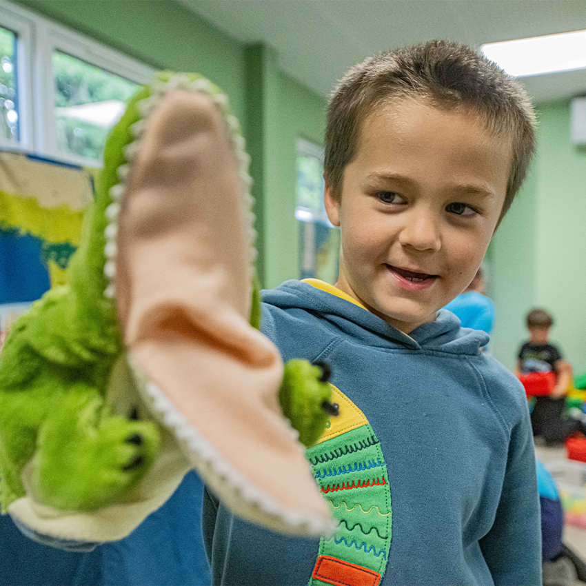 Young Boy With A Crocodile Hand Puppet 1000X1000p