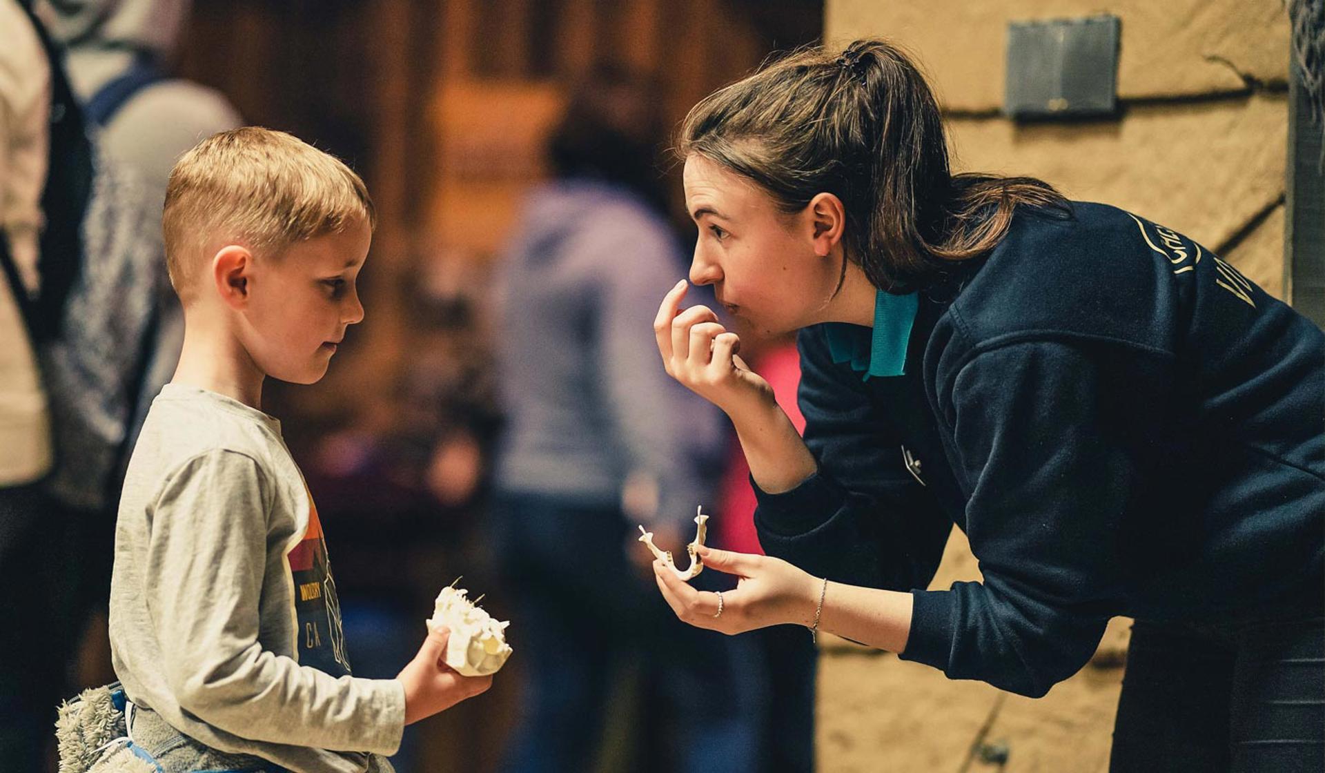 Volunteer Talking To A Young Boy At The Zoo