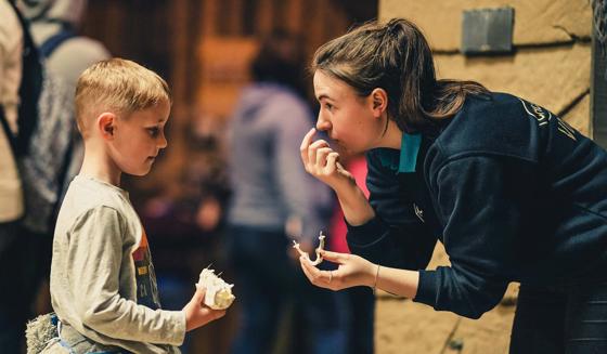 Volunteer Talking To A Young Boy At The Zoo