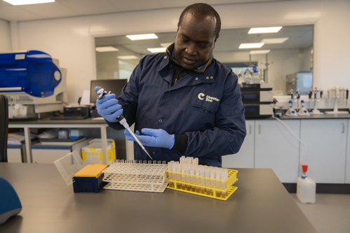 Cedric Khayale, a PhD scholar, pipetting samples into test tubes